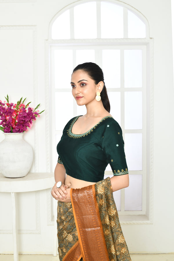 Bottle green pure raw silk elbow length blouse with golden floral embroidery in sleeves, front and back neck.